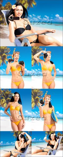 The beautiful brunette in a bathing suit with the camera and a video camera on a beach - Stock photo