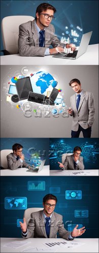 Stock photo -      /  Young man sitting at desk and typing on laptop with diagrams